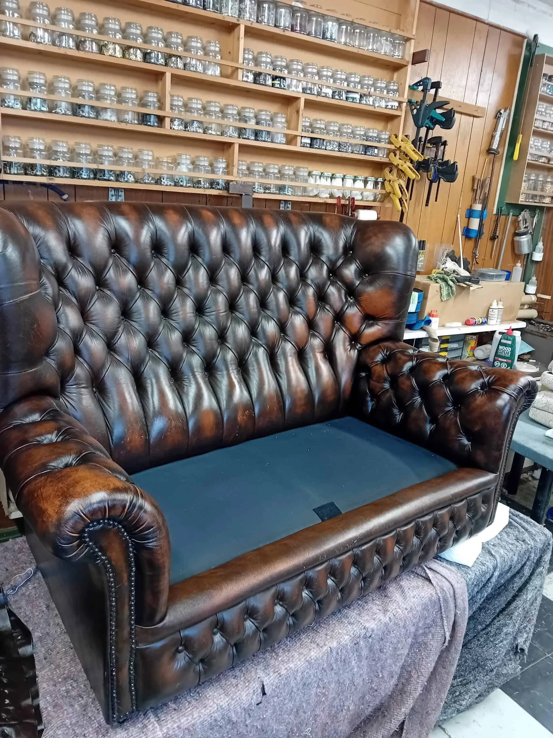 A restored leather Chesterfield sofa in Gareth’s workshop