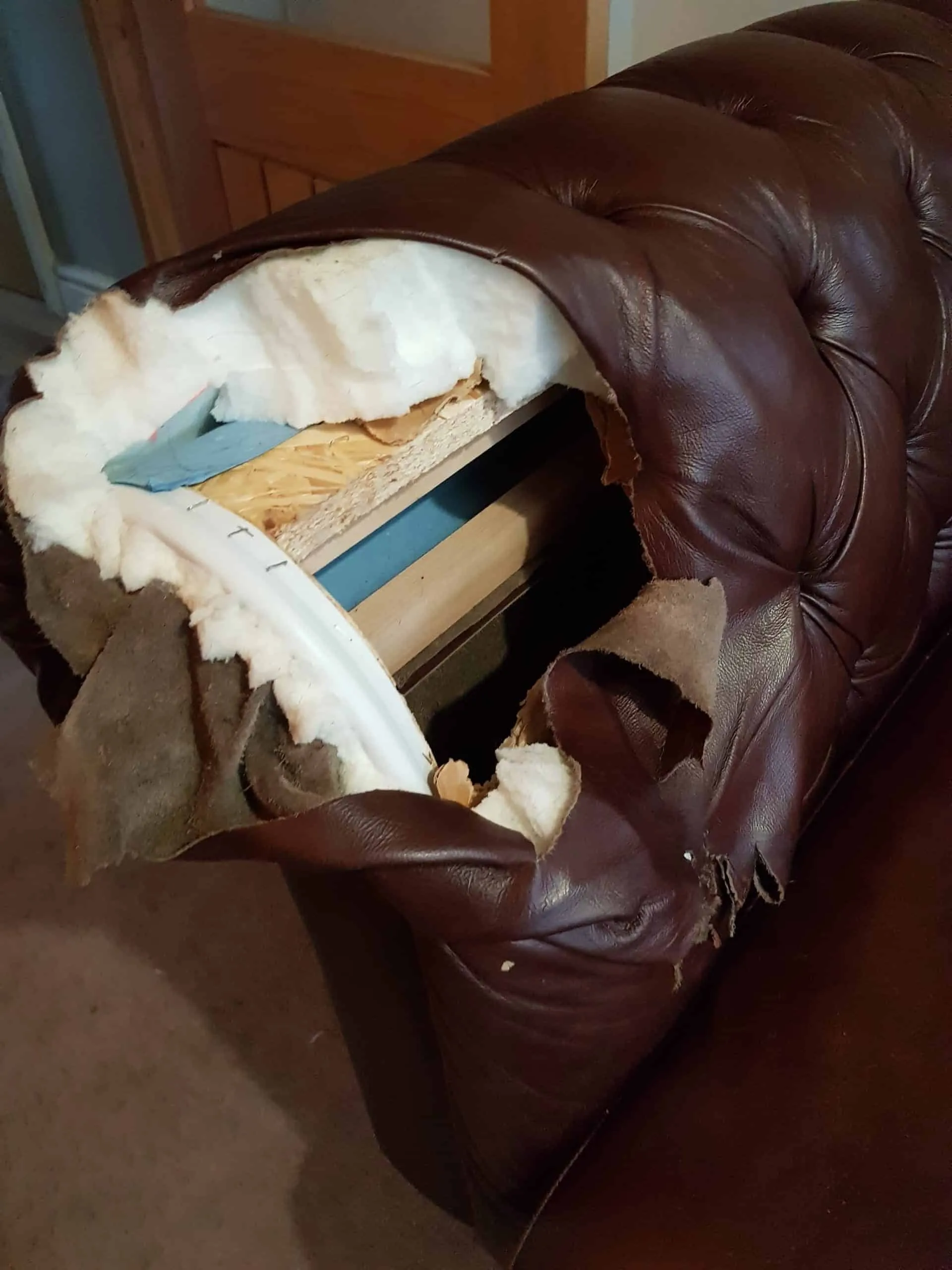 Chesterfield arm: torn leather replaced, before