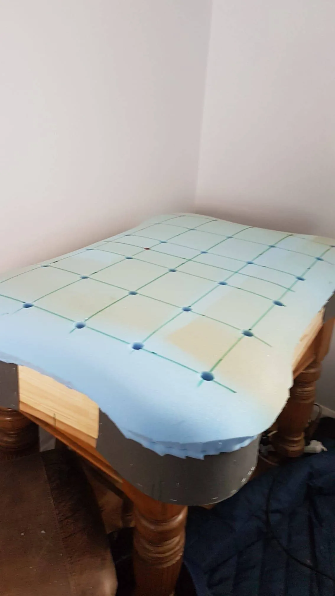 Buttoned leather footstool, before